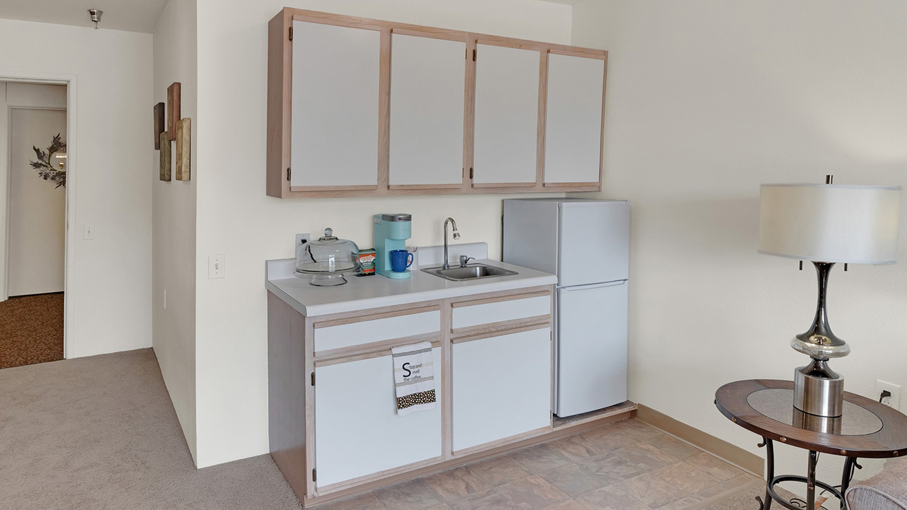 Holiday Wescourt apartment kitchenette with small sink and refrigerator