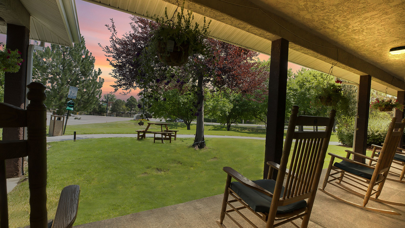courtyard patio with rocking chairs and views of the sunset